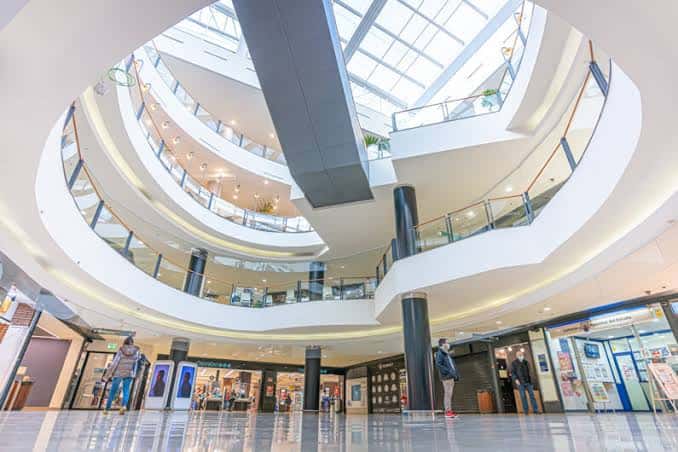 Vista interior del atrio principal con múltiples niveles y escaleras curvas