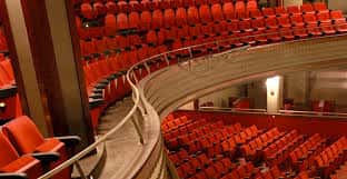 Detalle de las butacas rojas y la curva de los palcos del auditorio