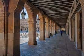 Pasillo con arcos y columnas de la Plaza Mayor, mostrando la arquitectura histórica