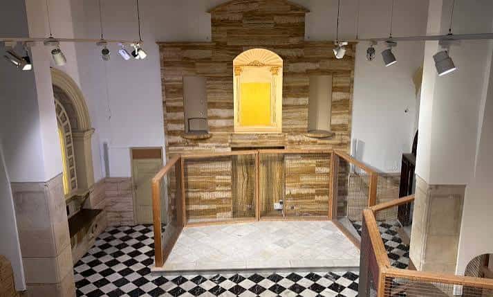 Espacio interior con suelo de baldosas y estructura de madera