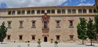 Fachada frontal del Palacio Arzobispal con escudo central, ventanas simétricas y árboles a los lados