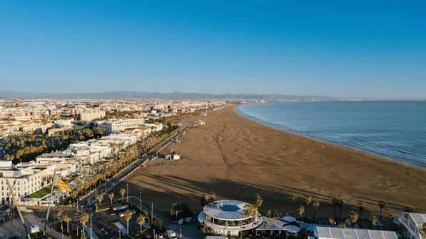 Vista aérea panorámica de la Playa de la Malvarrosa con el mar y la ciudad de Valencia al fondo