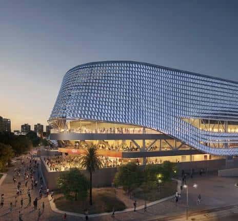 Render arquitectónico del Roig Arena al atardecer con iluminación exterior y acceso peatonal
