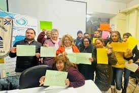 Participantes mostrando carteles en un evento del Centro Latinoamericano de Lleida