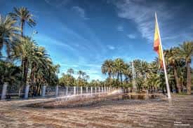 Plaza con fuente y bandera española en el Paseo de la Estación