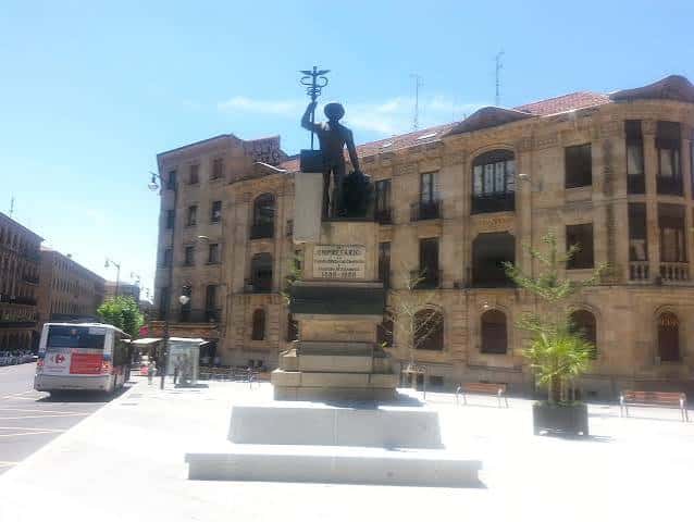 Monumento al Empresario en la Plaza del Comercio con fachada histórica al fondo