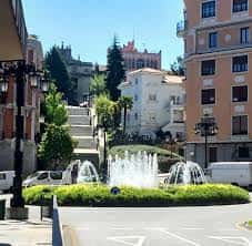 Plaza de San Miguel con fuente activa y escalinata hacia el fondo urbano
