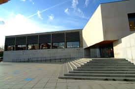Vista exterior de la Biblioteca Torrente Ballester con escaleras y fachada moderna