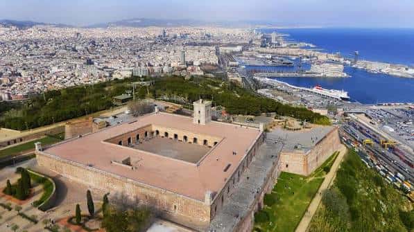 Vista aérea panorámica del Castillo de Montjuïc con la ciudad y el puerto de Barcelona al fondo