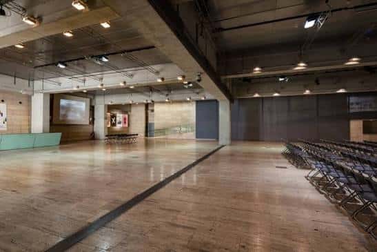 Interior del espacio expositivo o auditorio del CCCB con sillas dispuestas para eventos