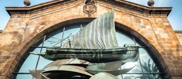 Fachada del Museo Marítimo con escultura de barco en la entrada