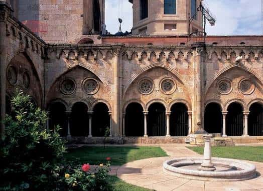 Claustro gótico con arcos apuntados y fuente central
