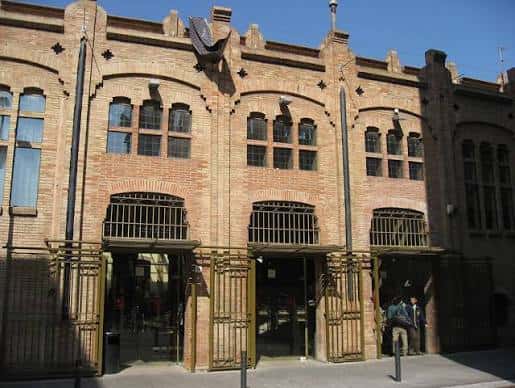 Fachada exterior de Can Massallera con arquitectura de ladrillo y detalles ornamentales