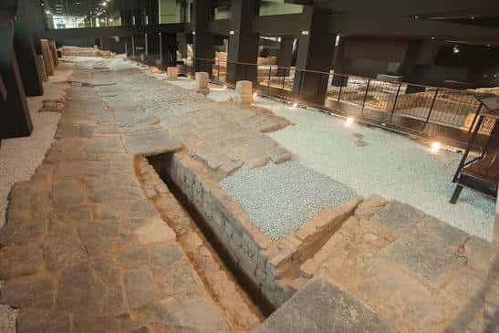 Detalle de la calzada romana y el canal de drenaje en el museo