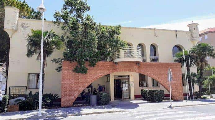 Fachada principal con arco de ladrillo y balcones