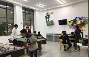 Sala de actividades recreativas con mesas de fútbol y juegos para jóvenes