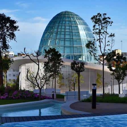 Edificio emblemático del parque con piscina y vegetación alrededor