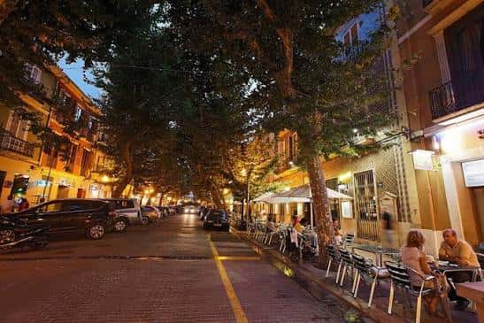 Calle Marqués de Campo en Dénia por la noche con ambiente de bares y restaurantes