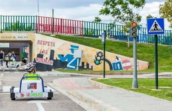 Pista de tráfico infantil con karting y señalización vial en el parque