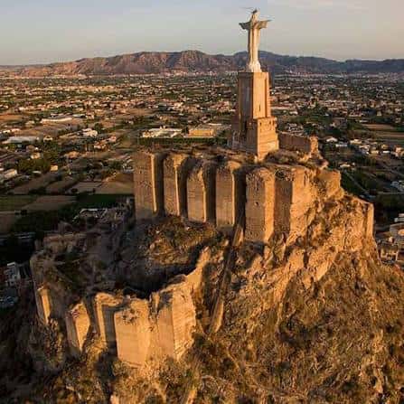Vista panorámica del Castillo de Monteagudo con el Cristo del Monteagudo al atardecer
