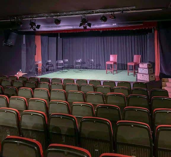 Escenario del Teatro Soho Club con sillas y cajas de escenario
