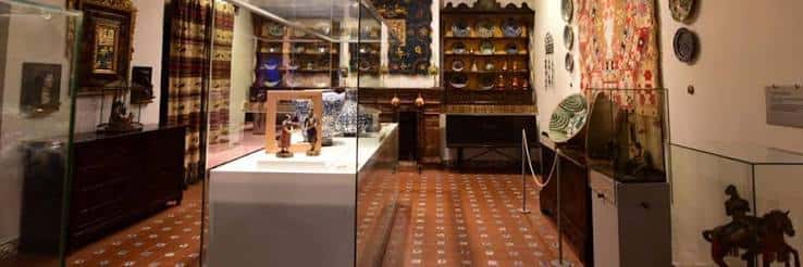 Interior del museo con vitrinas de cerámica y objetos históricos