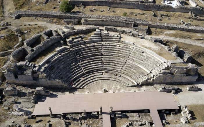 Vista aérea del anfiteatro romano con estructura de asientos en semicírculo y plataforma moderna frente a él