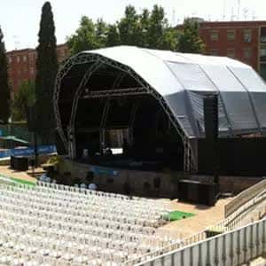 Escenario cubierto con estructura metálica y butacas dispuestas frente a él en el auditorio del recinto