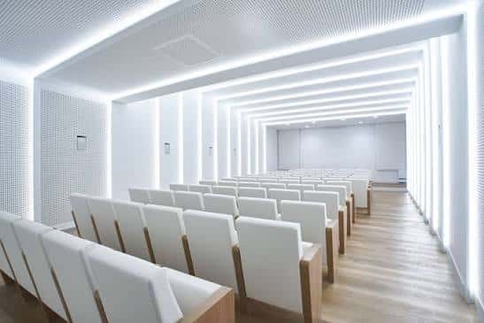 Sala de eventos con butacas blancas y diseño moderno