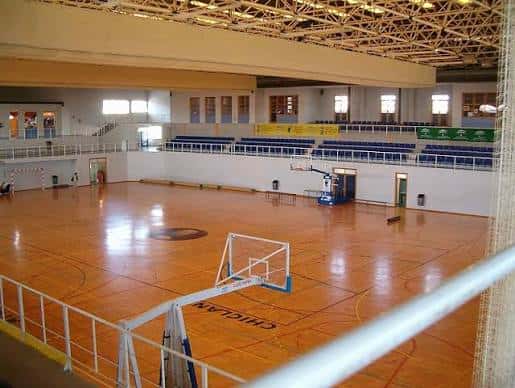 Interior del pabellón con pista de baloncesto y gradas
