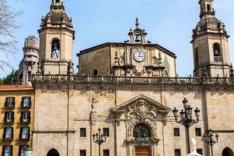 Fachada principal de la Iglesia de San Nicolás con sus torres y reloj