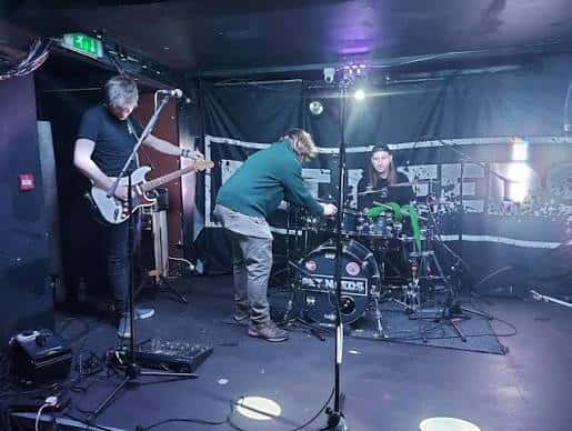 Banda actuando en el escenario de The Bear Cave