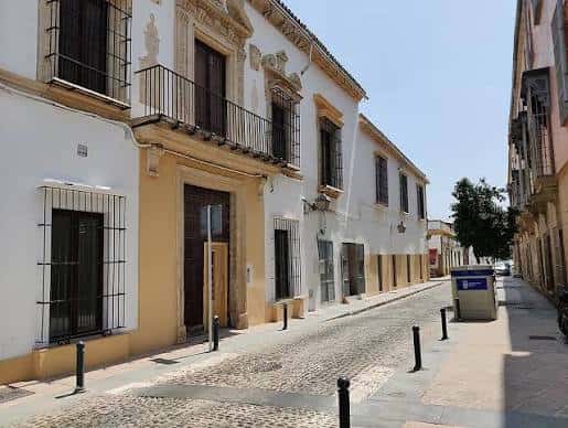 Vista de la calle donde se encuentra la Casa de las Mujeres, mostrando su fachada tradicional andaluza