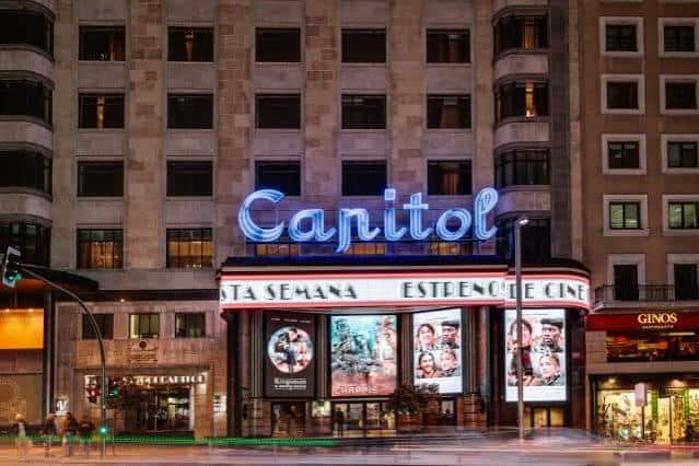 Fachada nocturna del Teatro Capitol Gran Vía con iluminación neón y cartelera de estrenos