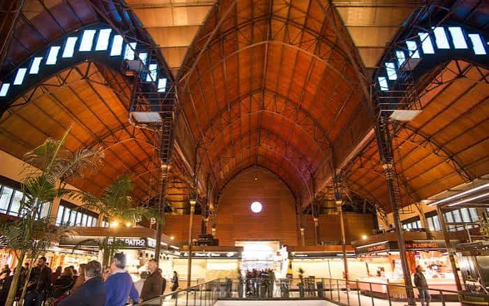 Interior del mercado con la imponente estructura de techos de madera y vigas de hierro