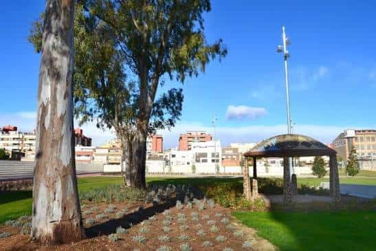 Vista panorámica del Parc 1 d'Octubre con árboles y un kiosco bajo cielo azul