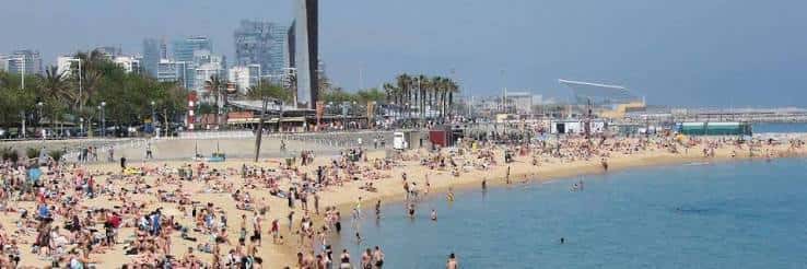 Playa del Bogatell con gente disfrutando del sol y el mar