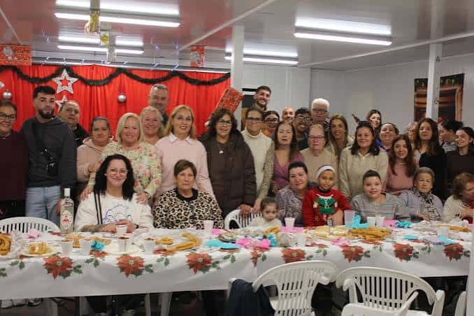 Grupo de vecinos reunidos en una chocolatada navideña en la barriada de Juan XXIII