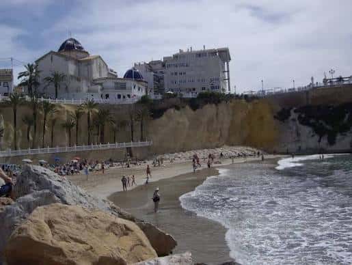Playa del Mal Pas con personas disfrutando y edificios blancos al fondo