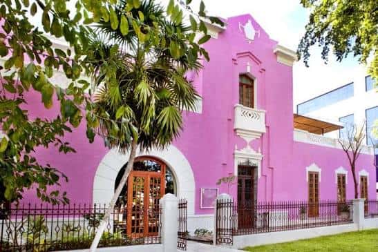 Fachada exterior del hotel Rosas & Xocolate con su distintivo color rosa y arquitectura colonial