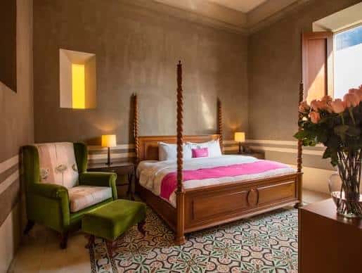 Habitación de lujo con cama de cuatro postes y decoración elegante