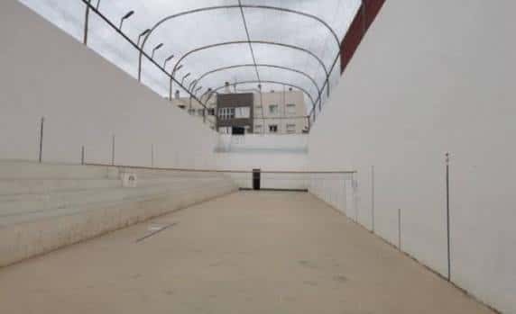 Vista interior del Trinquete José María Veguer en Torrent, mostrando las gradas y la cancha bajo techo
