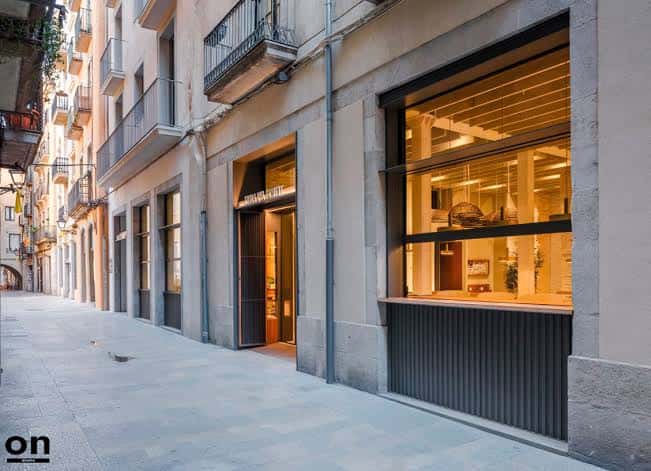 Fachada exterior de El Foment en calle tranquila, mostrando su integración urbana