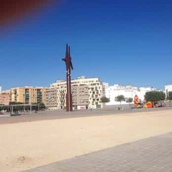 Vista panorámica de la Plaza Mayor con escultura y edificios residenciales al fondo