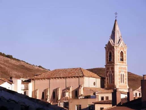 Vista panorámica de la Iglesia del Salvador con su torre y fachada bajo cielo despejado
