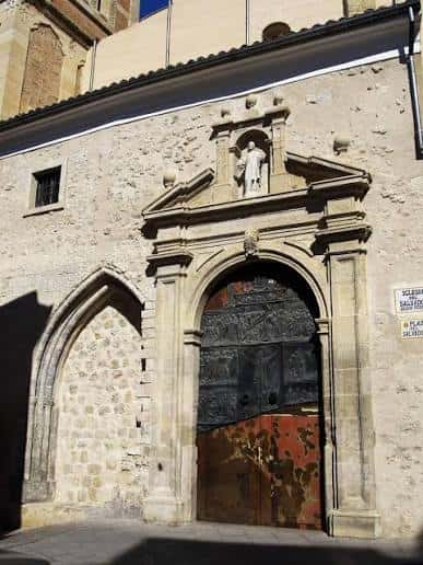 Detalle de la puerta principal de la iglesia con escultura y arco de entrada