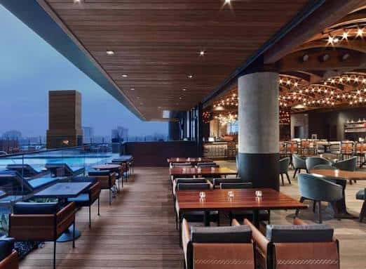 Terraza exterior con piscina y zona de comedor al atardecer, ideal para celebraciones