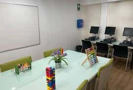 Sala de informática con ordenadores y mesa de trabajo
