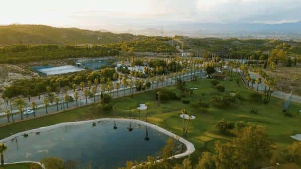 Panorámica del complejo de golf al atardecer con vistas a la ciudad