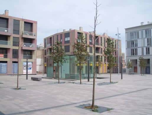 Plaza vacía con árboles jóvenes y arquitectura moderna en Vilanova i la Geltrú